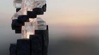 Abstract geometric staircase with transparent and dark cubic blocks ascending against soft gradient sky background for modern design concepts.