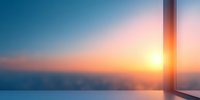 Minimalist architectural corner with panoramic window view of sunset sky and horizon, soft gradient colors from blue to orange create serene atmosphere.