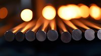 Unlit wooden matches arranged in row with warm glowing bokeh lights in background creating atmospheric composition for concepts of potential and anticipation.