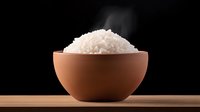 Steaming hot white rice served in terracotta bowl on wooden surface against black background with rising steam, dramatic food photography for restaurant menu.