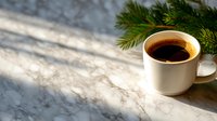 Steaming cup of black coffee on marble countertop with pine branch, morning sunlight casting shadows through window, cozy winter atmosphere.