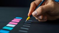 Hand holding blue pen marking checklist with pink and blue sticky notes on dark background, business planning and task management concept.