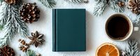Cozy winter flat lay with teal book, coffee cup, pine branches, cones and spices on white background for seasonal reading and relaxation themes.