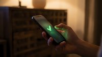 Hands holding smartphone with green checkmark on screen, symbolizing approval, verification, success, or confirmation in digital communication and mobile technology applications.