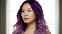 Young Asian woman with vibrant purple ombre hair looking confidently at camera with natural makeup and soft lighting for beauty and fashion concepts.