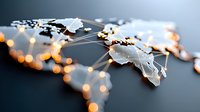 Digital world map with glowing connection points and network lines illuminated by warm light on dark background, representing global technology infrastructure.
