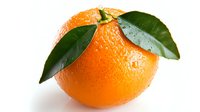Fresh ripe orange with water drops and green leaves on white background, isolated citrus fruit for healthy eating and juice packaging design.