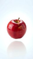 Fresh red apple with water droplets isolated on white background, suitable for food, nutrition, health and wellness design projects.