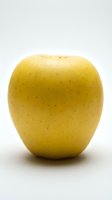 Fresh yellow apple isolated on white background, ready for food and nutrition design projects, healthy eating concepts, and culinary applications.