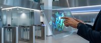 Professional using futuristic holographic interface with digital charts and data visualization in modern office environment for business analytics.