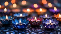 Ornate metal oil lamps with flickering flames create warm ambient lighting against colorful bokeh background for festive celebrations and spiritual ceremonies.