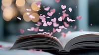 Open book with pink hearts floating above pages against blurred bokeh background, romantic literature and storytelling concept for Valentine's Day cards and social media.