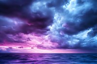 Dramatic storm clouds in vibrant purple and blue hues over calm ocean waters creating moody seascape for backgrounds and atmospheric designs.