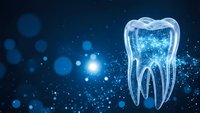 Digital tooth hologram on blue background with glowing particles and bokeh lights for dental technology and healthcare innovation concepts.