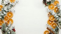 Dried orange slices and eucalyptus leaves arranged on white background with copy space for holiday, wellness, and seasonal design projects.
