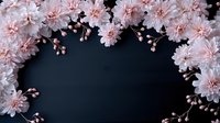 Delicate pink chrysanthemum flowers creating natural frame border on dark background, copy space for text in center. Romantic floral composition.