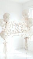 Elegant Happy Birthday greeting with pearl white balloons and ribbon bows in a soft neutral setting, perfect for cards and celebrations.