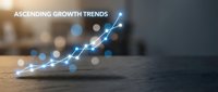 Glowing blue arrow chart showing upward business growth trends on wooden surface with blurred office background for financial presentations.