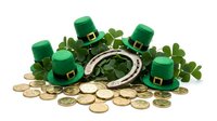 Leprechaun hats with golden coins and shamrock leaves arranged on white background, isolated design element for St. Patrick's Day celebrations and festive projects.
