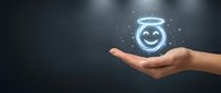 Caucasian hand holding glowing neon smiley face with halo symbol, representing customer satisfaction, positive feedback, and excellent service quality for business concepts.