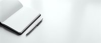 Minimalist workspace with closed laptop and black pen on clean white surface for business and productivity concepts.