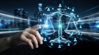 Digital justice scales with network connections floating above businessman hand in futuristic legal technology concept for law firm automation and legal services.