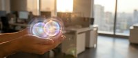 Hand holding glowing digital hologram sphere with data visualization in modern office workspace with city skyline view for technology and innovation concepts.