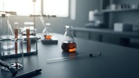 Modern laboratory workspace with scientific glassware and equipment on dark counter for research and analysis experiments.