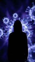 Silhouette of person surrounded by glowing virus particles in purple light representing pandemic health crisis and infectious disease outbreak.