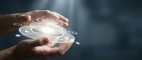 Hands holding glowing digital hologram with concentric circles and light rays, representing technology, innovation, and future digital solutions for business applications.