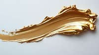 Luxurious gold metallic paint smear with textured edges and glossy finish on white background, isolated cosmetic product sample for makeup and beauty industry.