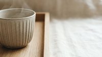 Ceramic mug with ribbed texture on wooden tray, minimalist home decor and tableware styling for interior design projects.