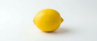 Fresh yellow lemon with textured skin isolated on white background, suitable for food, beverage, health and culinary design projects.