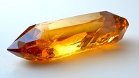 Glowing amber crystal with geometric facets and natural inclusions illuminated from within, showcasing rich honey-golden tones and transparent surfaces.