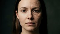 Young Caucasian woman portrait showing aging process with half face wrinkled and half smooth skin for skincare and beauty treatment concepts.