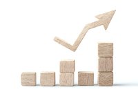 Wooden blocks arranged in ascending order with upward arrow showing growth trend on white background. Business concept for success and progress.