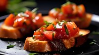 Fresh diced tomatoes and herbs on toasted bread slices create classic Italian bruschetta appetizer served on dark plate with dramatic lighting.