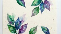 Watercolor botanical leaves in green and purple hues on textured paper background for natural design projects and organic branding materials.