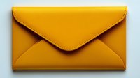 Yellow leather envelope clutch purse with stitched edges isolated on white background for fashion accessories and handbag design projects.