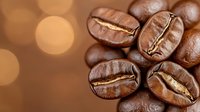 Fresh roasted coffee beans macro shot with warm bokeh background, showing rich brown color and distinctive groove detail. For cafe menu and food packaging design.