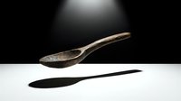 Antique wooden spoon floating above white surface with dramatic shadow cast below against dark background under spotlight illumination.