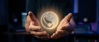 Hands protecting glowing heart symbol representing care, love, healthcare protection, charity support, and emotional wellness in digital environment.