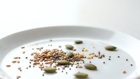 Healthy breakfast bowl with mixed seeds, nuts and yogurt for nutritious morning meal and wellness lifestyle.