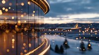 Magical evening cityscape with bokeh lights reflecting on glass surface against mountain backdrop and dramatic sky at dusk, creating dreamy atmosphere.