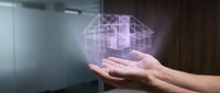 Hands holding glowing digital wireframe building model, representing architecture technology, virtual construction planning, and smart building design solutions.