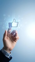 Businessman hand touching glowing thumbs up like icon on blue background representing social media engagement and positive feedback for digital marketing.