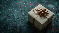Gift box wrapped in kraft paper with golden bow on dark green textured background with red glitter sparkles scattered around creating festive holiday atmosphere.