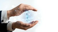Businessman hands holding glowing digital globe with sparkling light effects on white background, representing global business, technology, and worldwide connectivity.