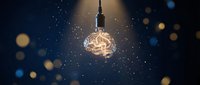 Glowing vintage Edison bulb hanging against dark blue starry night sky with golden bokeh lights creating magical atmosphere for creative concepts.