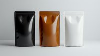 Three standing pouch bags in black, brown and white colors on gray background. Blank foil packaging mockup for food, coffee or cosmetic products.